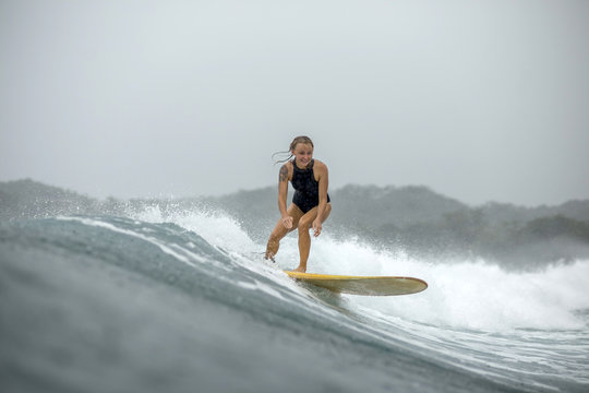 Indonesia, Java, woman surfing