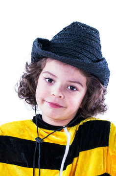 Cute little boy in a bee costume looks at the camera. Close-up. White background.