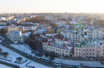 Fototapeta premium panoramic view of the snow-covered Vyborg with colorful houses roofs on the banks of the river embankment was a bright sunny day