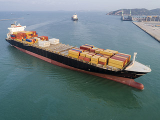 commercial ship of container vessel just arrival in approach to the channel due of the port