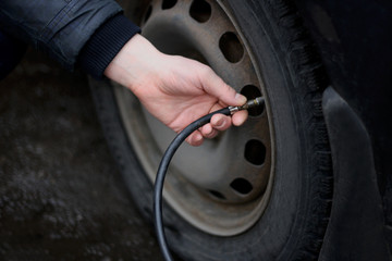 Pumping up the tyres of the vehicle.