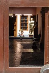 View through door to a light-flooded patio with sculpture in a colonial building, Lima,Peru