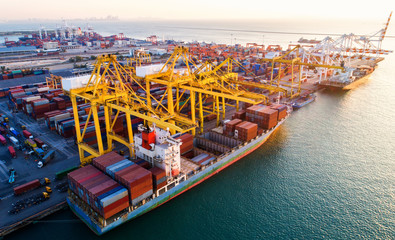 container ship in import export and business logistic.By crane ,Trade Port , Shipping.cargo to...