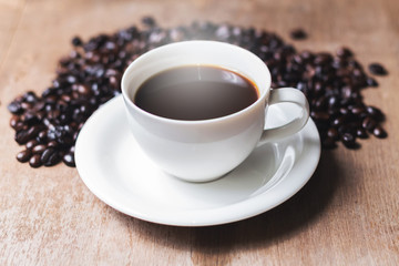 Cup of hot coffee on a old wooden table. Top shot.