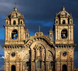 Fototapeta premium Close up of Catedral La Compania in sunlight with dramatic sky after a rain shower, Cusco, Peru