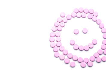 Smile face of pink pills  on white background. Tablets of drug for asthma treatment