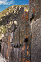 Impressive Inca wall with orange lichen, Araqama Ayllu, Ollantaytambo, Sacred Valley, Peru