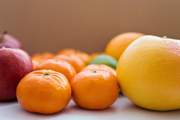 Close-up of grapefruit, tangerines and red apples