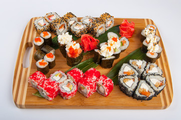 sushi rolls assorted on a wooden Board concept: delivery