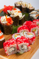 sushi rolls assorted on a wooden Board concept: delivery