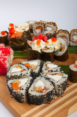 sushi rolls assorted on a wooden Board concept: delivery