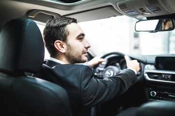 Fototapeta na wymiar Close-up of man hands holding steering wheel while driving car
