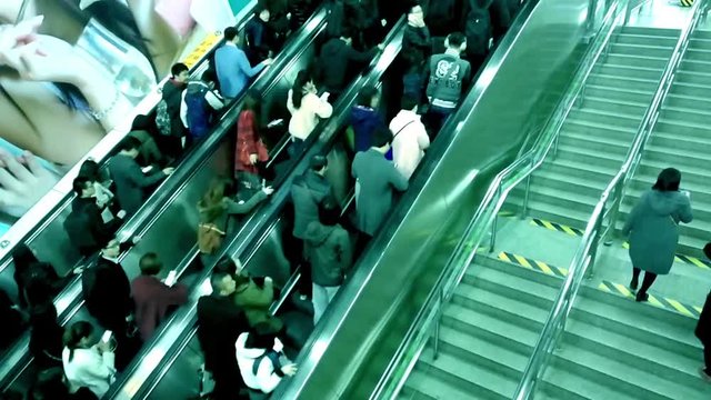 People riding escalators in the station. Time Lapse 