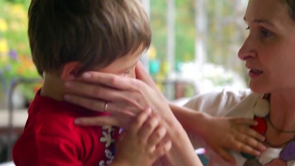 Moment of tenderness between mother and her son. Mom hugging her 4-6 year old son in balcony. Candid moment of a young mom with her child. Son hugging his mom in an affectionally caring loving way