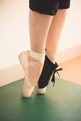 dancer girl feet in sneakers and ballet shoes closeup