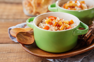 Healthy Homemade Oatmeal with apples and cinnamon for breakfast. Shallow DOF
