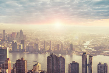 New York city skyline in the morning, sunrise in background.