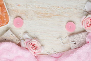 Spa settings with roses. Various items used in spa treatments on white wooden background.