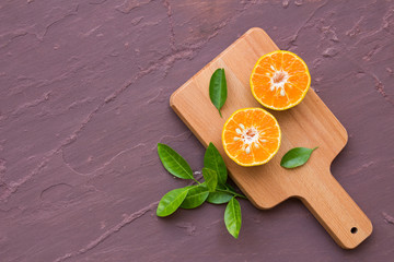 Still life with orange on brown stone table background