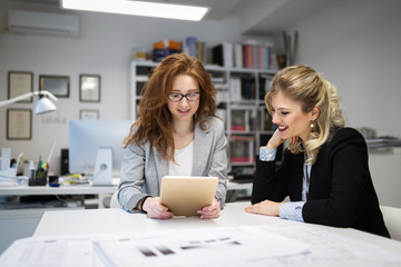 Businesswomen and architects  talking in office