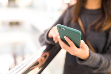 Woman sending sms on smart phone