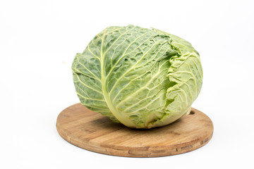 Fototapeta premium Green fresh cabbage on the kitchen wooden board