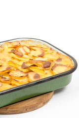 Mousaka on the kitchen wooden board isolated over white