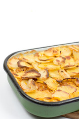 Mousaka on the kitchen wooden board isolated over white