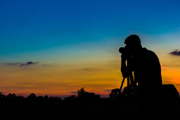 Silhouette photographer with sunset