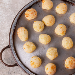 Brazilian snack cheese bread (pao de queijo) on oven-tray