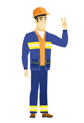 Asian builder showing the victory gesture.