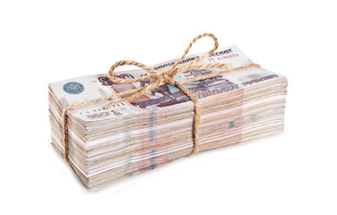 A large amount of Russian paper money in the stack, tied with a rope. Isolated on a white background.