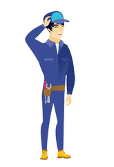 Young asian mechanic laughing.