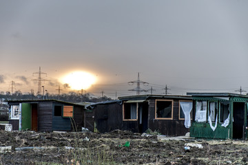 Fototapeta premium Old creepy dark abandoned destructive dirty house broken windows sunset