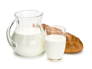 Glassware filled with milk and a white loaf long loaf