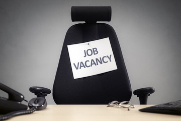 Office chair with job vacancy sign