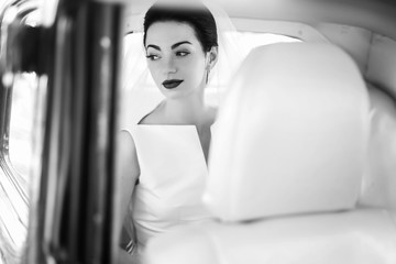 elegant handsome stylish groom holding gently gorgeous bride. unusual luxury wedding couple in retro style. romantic moment. black white photo