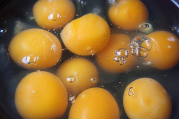 raw eggs in a black plate