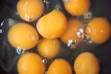 raw eggs in a black plate