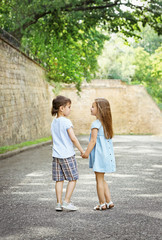 Obraz premium Small friendly kids on street
