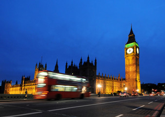 Big Ben and a red double-decker bus at night, London,