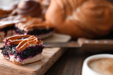 Slice of tasty fruit pie on wooden table