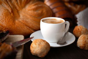 Cup of coffee and different bakery products