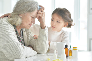 Obraz na płótnie Canvas Granddaughter takes care of a sick grandmother