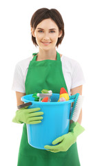 Young woman holding bucket with cleaning supplies on white background