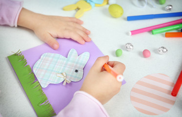 Obraz na płótnie Canvas Little girl painting handmade Easter card