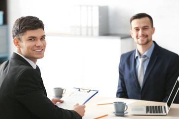 HR manager interviewing young man in office