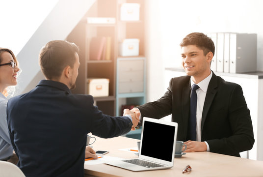HR manager shaking hands with applicant