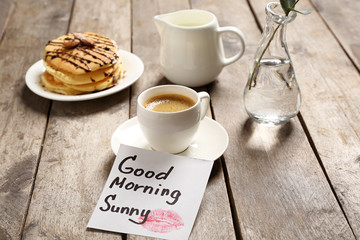 Delicious breakfast and GOOD MORNING greeting note on wooden table