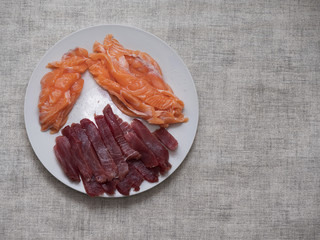 Salmon and tuna pieces cut for sushi.